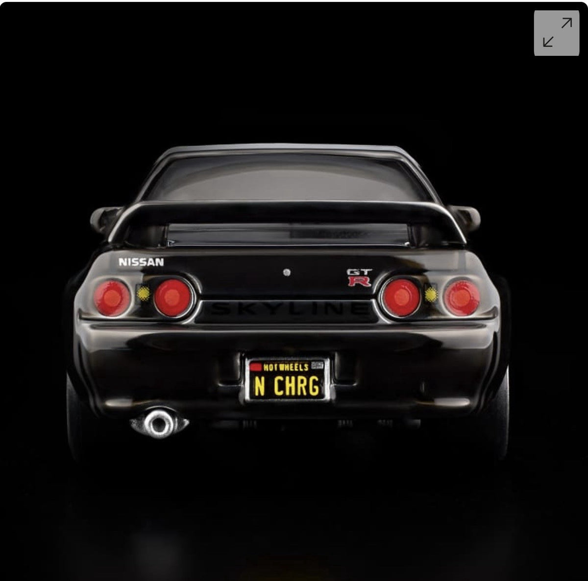 Die-cast sports car model, rear view with Skyline lettering and round red tail lights