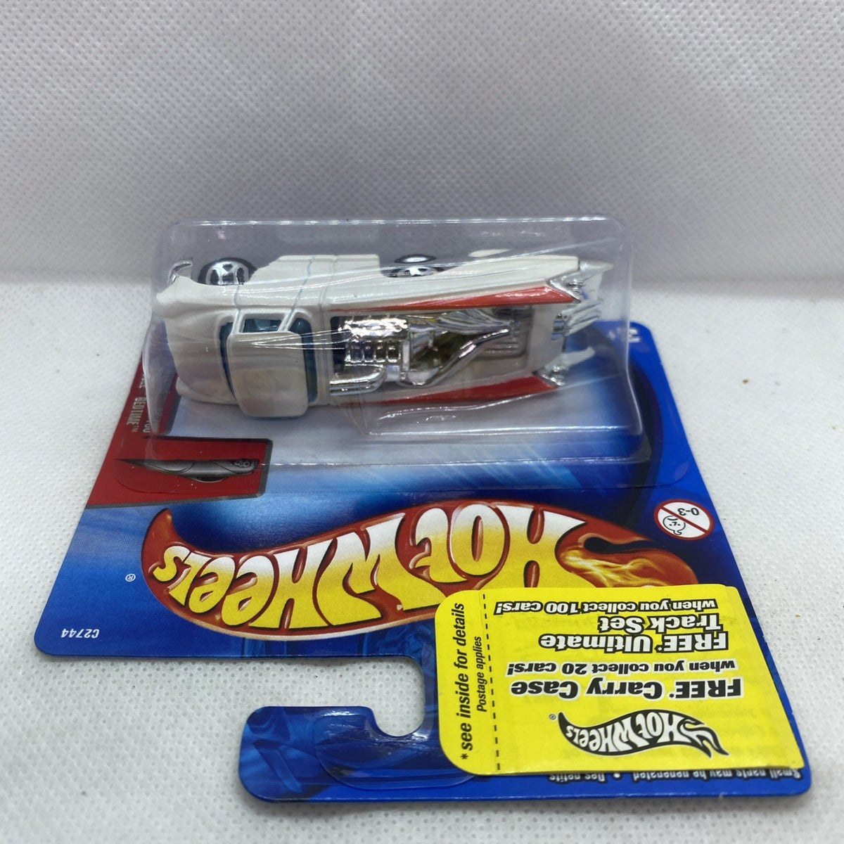 Hot Wheels car in blister pack with white pickup and red engine details