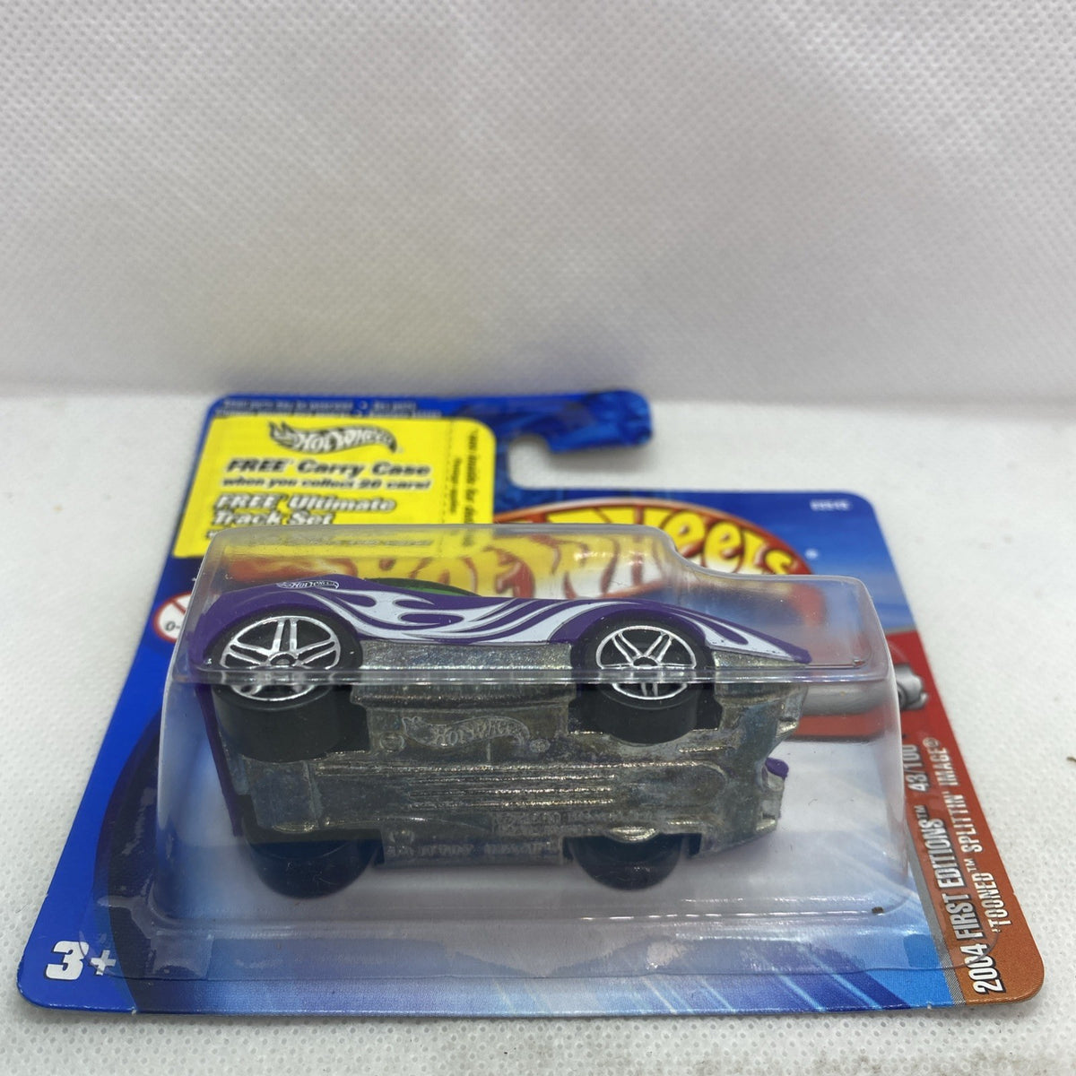 Hot Wheels die-cast car on short card with purple flame graphics in clear blister