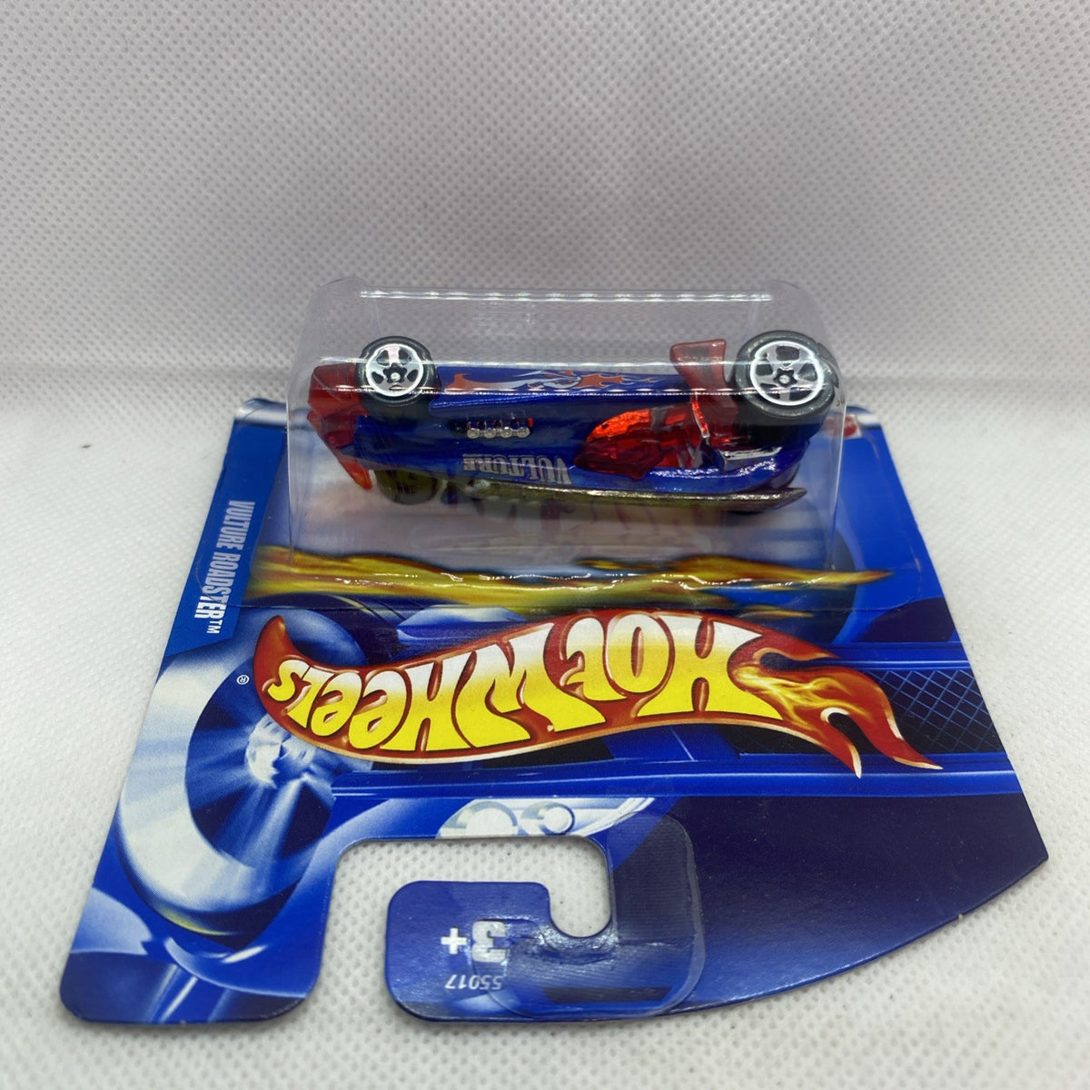 Die-cast car in clear blister: blue Vulture Roadster with red flame graphics, silver wheels