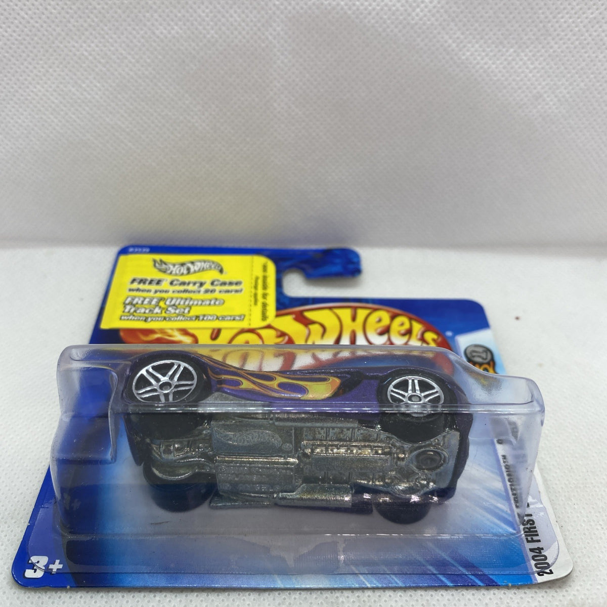 Hot Wheels purple flame car shown in clear blister with blue card backing