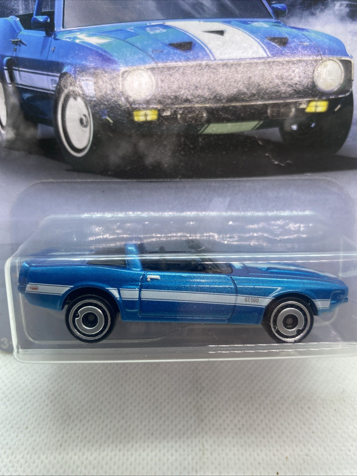 Blue '69 Shelby GT500 Hot Wheels die-cast car side view in clear blister