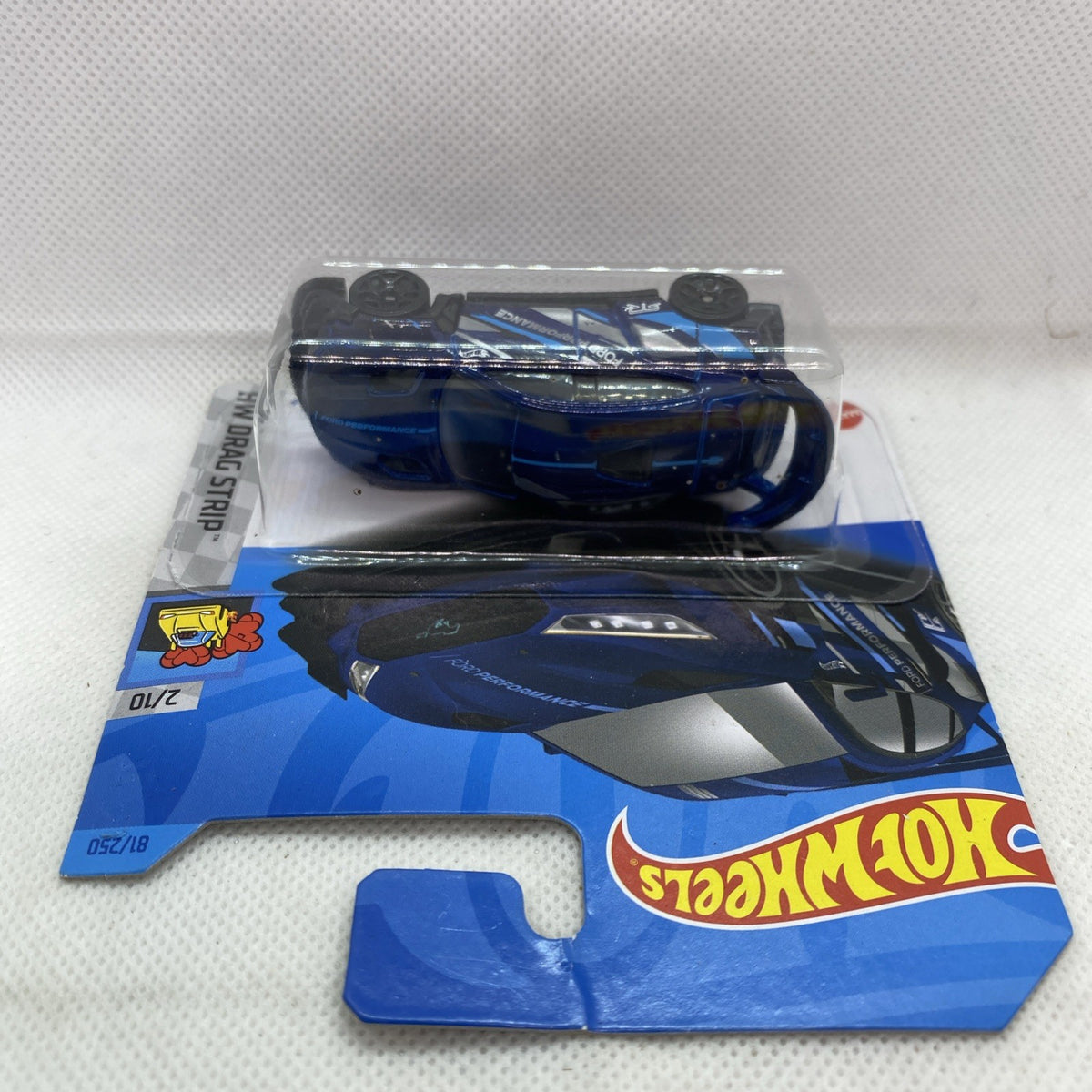 Hot Wheels die-cast Mustang Mach-E toy car, blue body with black wheels, in pack
