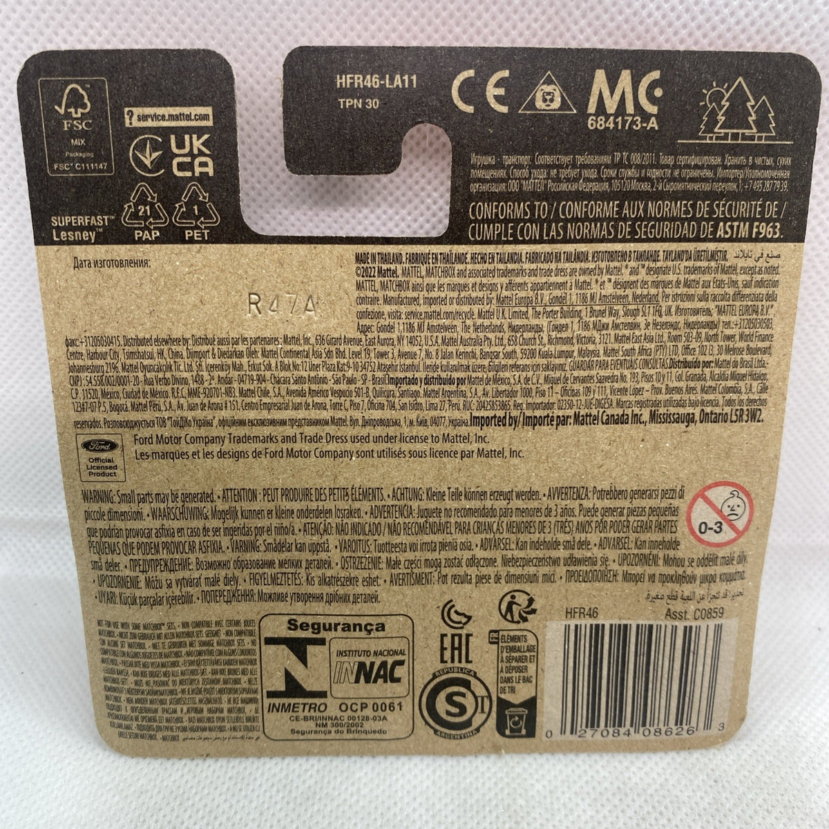 Back of Matchbox blister pack with barcode, safety icons, and toy car label