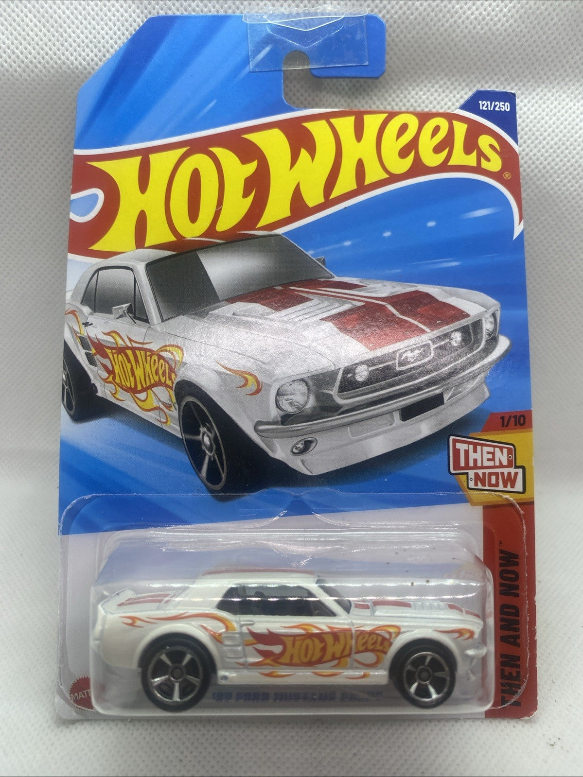 Hot Wheels die-cast car in blue blister pack, sealed with “Then and Now” badge