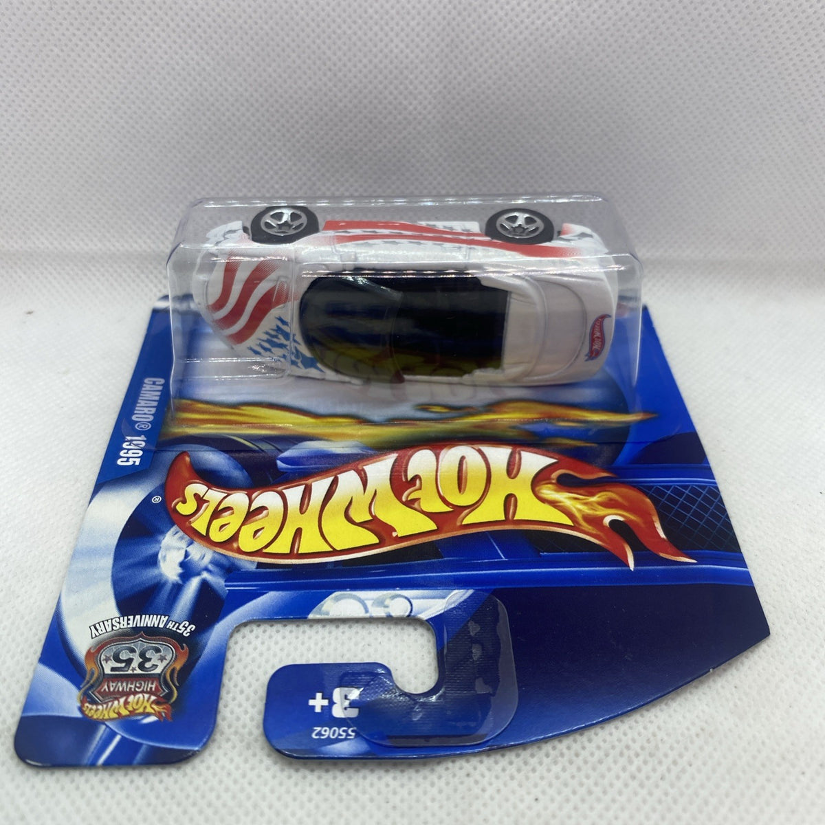 Hot Wheels die-cast Camaro convertible side view in blister, white with red stripe