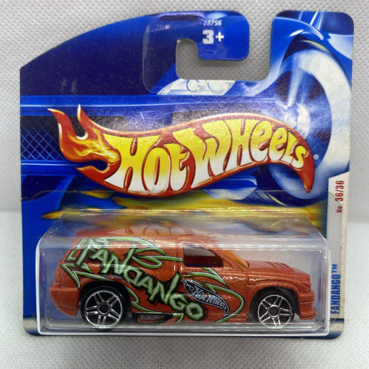 Hot Wheels die-cast car in blister pack, orange body with green graffiti-style flames