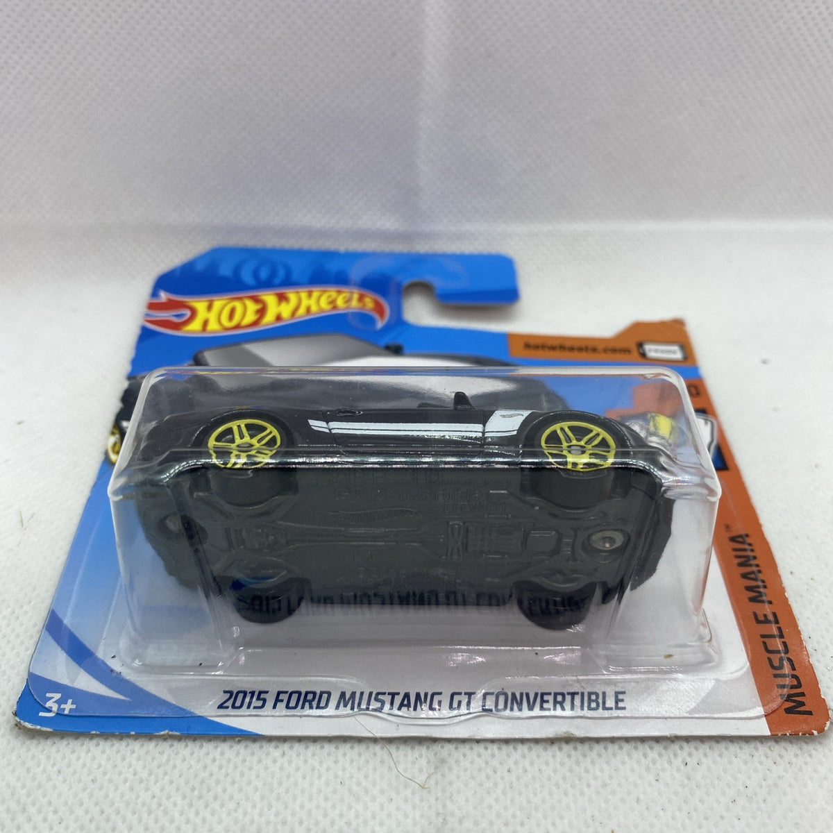 Hot Wheels die-cast black convertible toy car in blister pack with yellow wheel accents