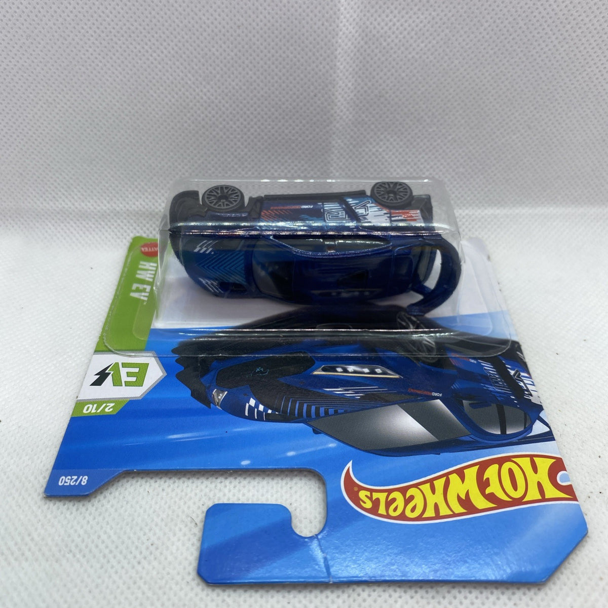 Sealed Hot Wheels die-cast EV car in blue blister pack with hang tab