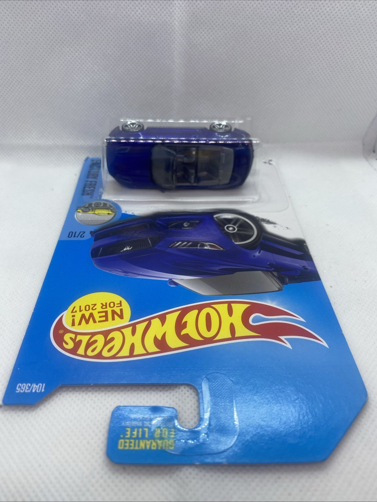 Hot Wheels die-cast toy car with blue base card and clear blister, rear view
