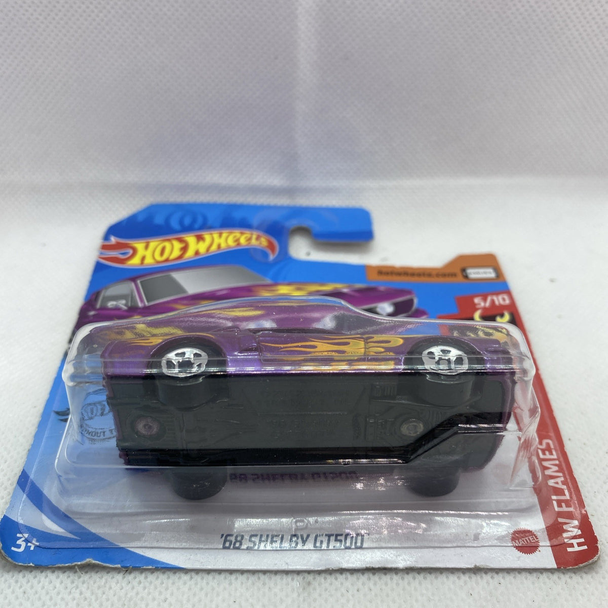 Hot Wheels die-cast car blister pack, side view of purple flame car in clear cover