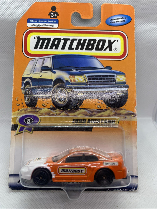 Sealed Matchbox die-cast car blister with orange and white 1999 Mustang