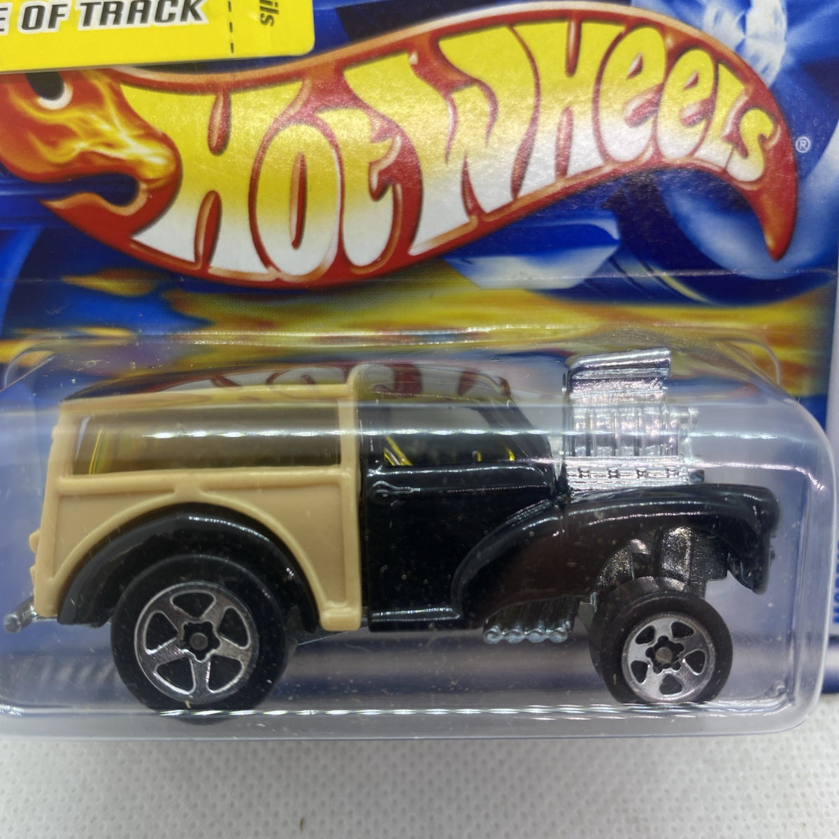 Close-up side view of black and tan Morris Wagon die-cast in clear blister