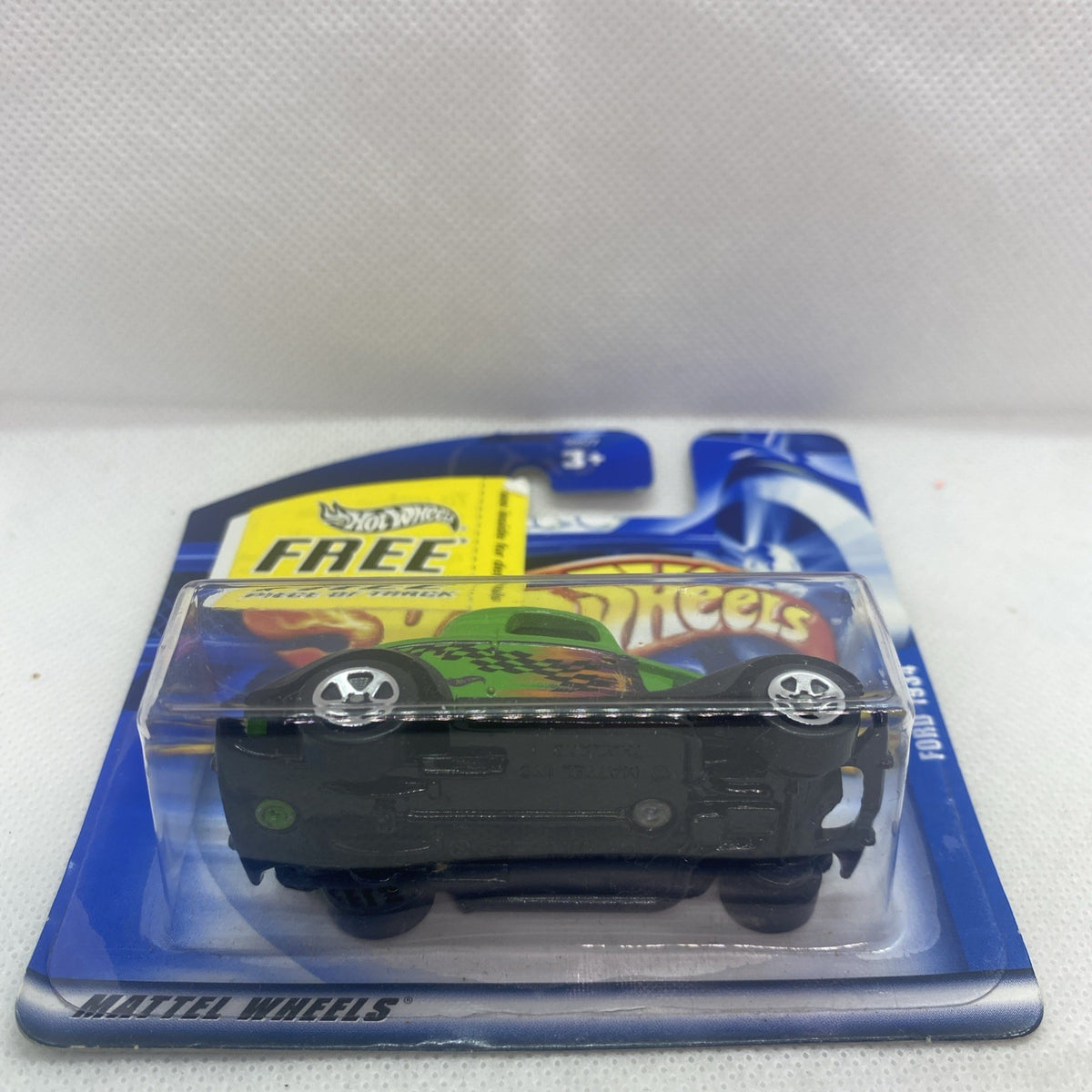 Hot Wheels green '34 Ford die-cast car through clear blister, front view