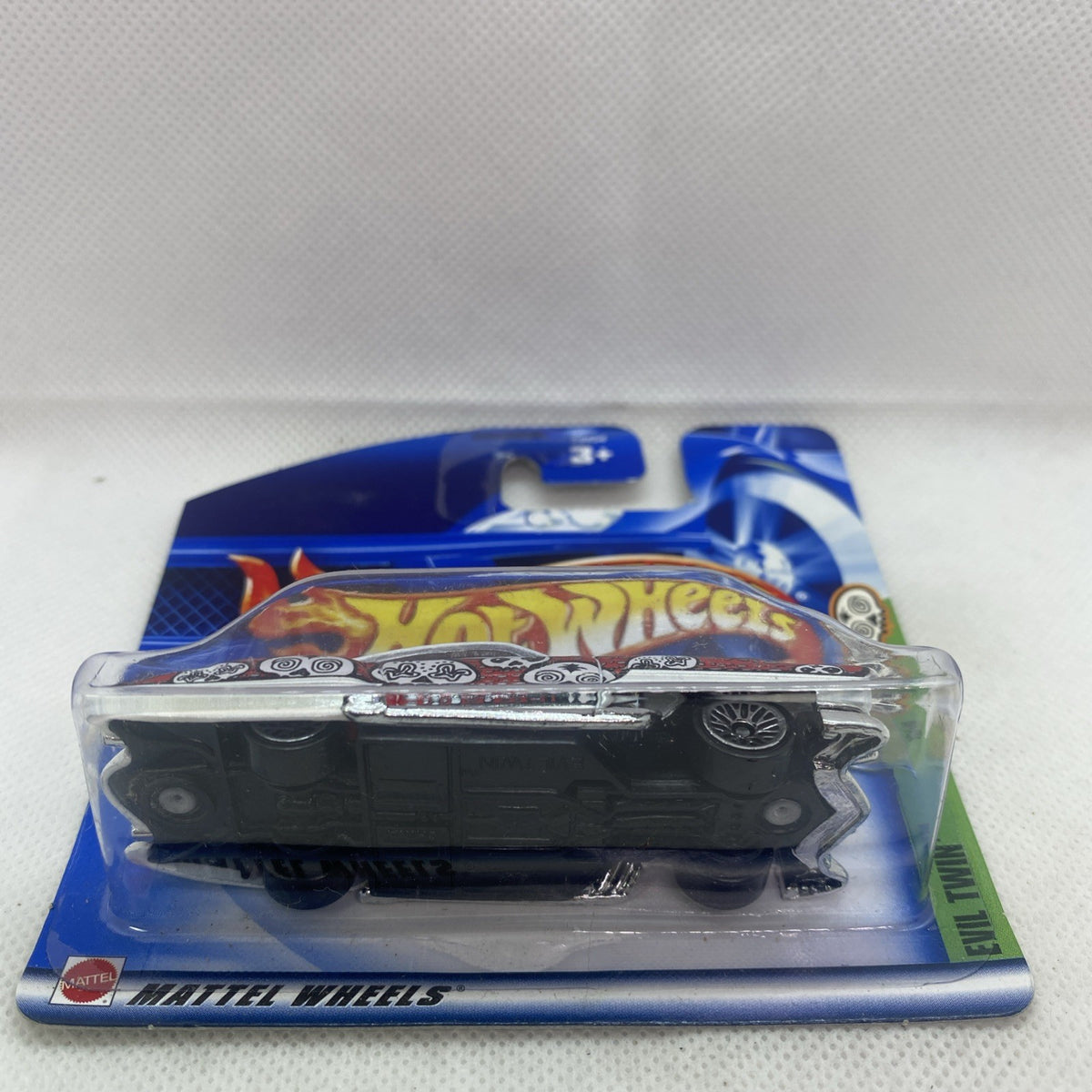 Hot Wheels die-cast car blister pack, side view with wheels visible