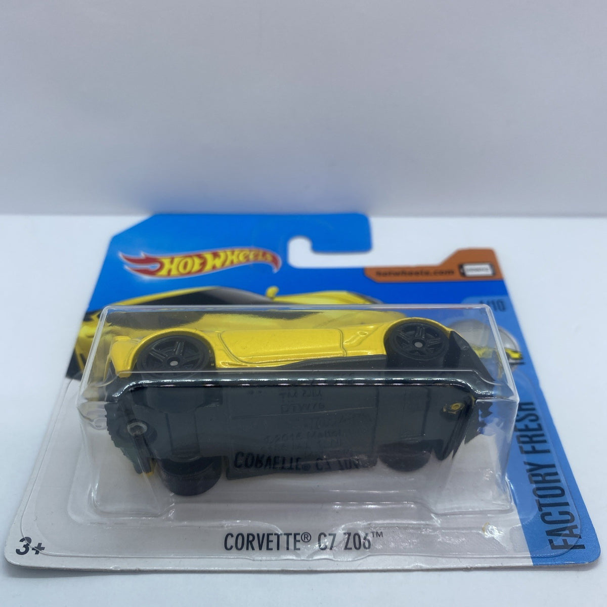 Hot Wheels Corvette C7 Z06 diecast in clear blister with yellow body and black top
