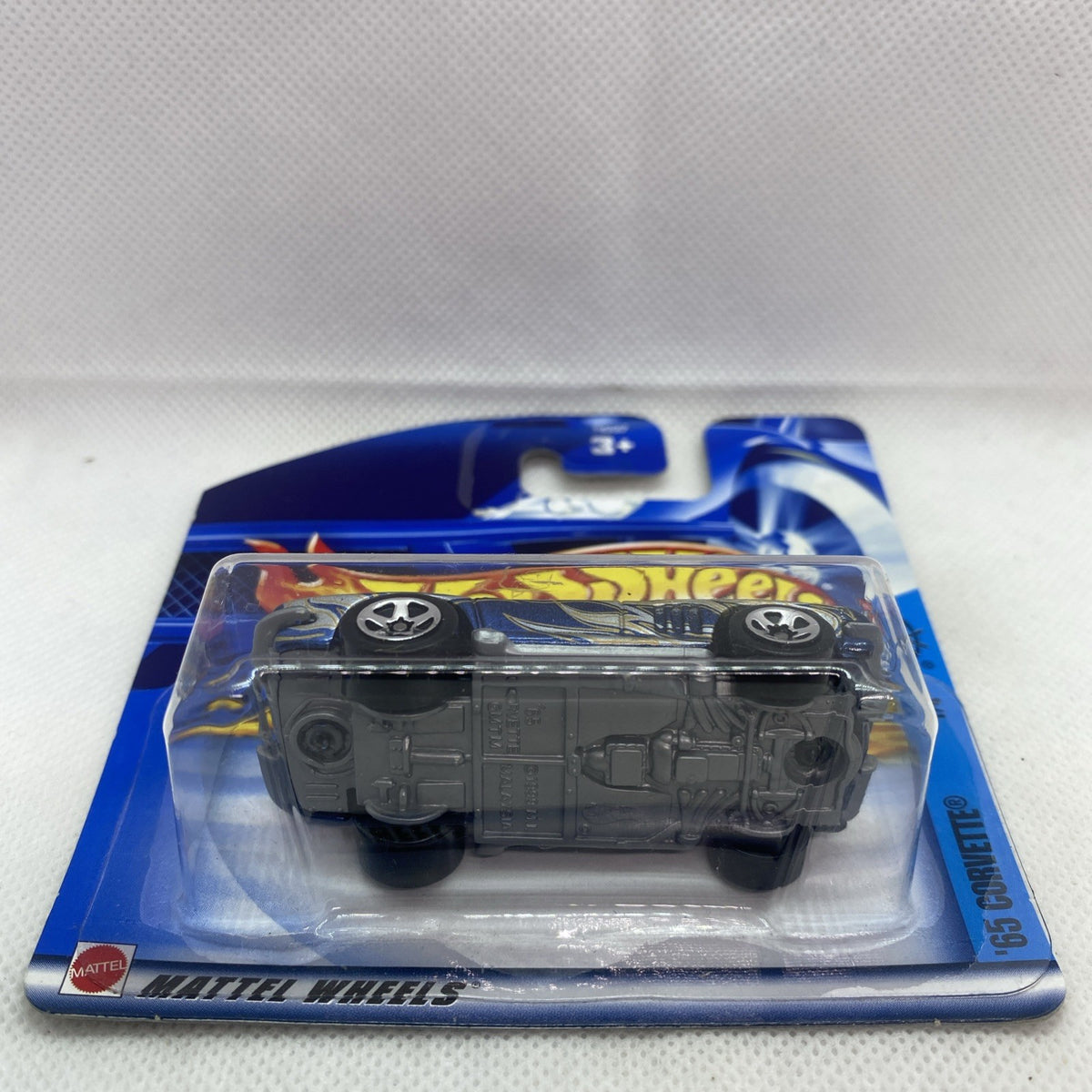 Hot Wheels die-cast Corvette in clear blister on short card, top view of engine detail
