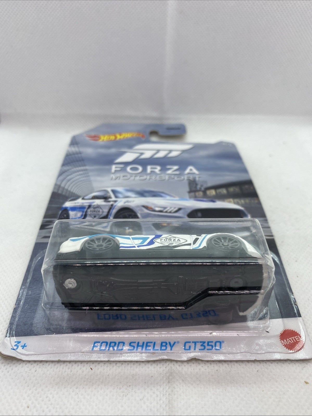Hot Wheels Ford Shelby GT350 Forza blister pack, white and blue toy car in window