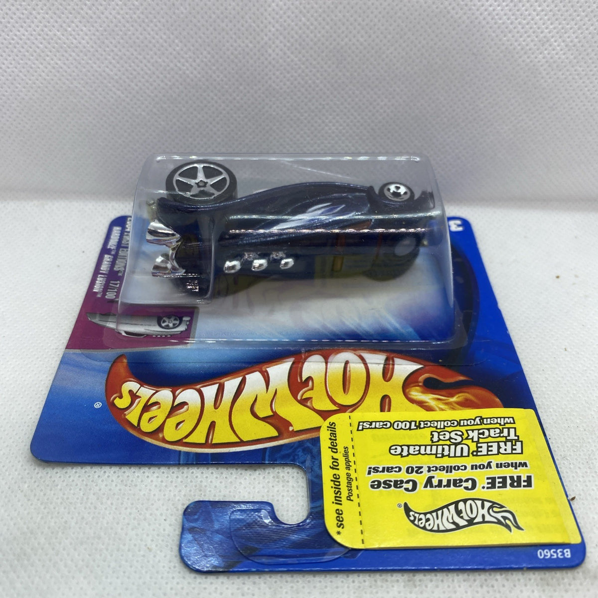 Hot Wheels die-cast car in clear blister, dark blue body with chrome wheels