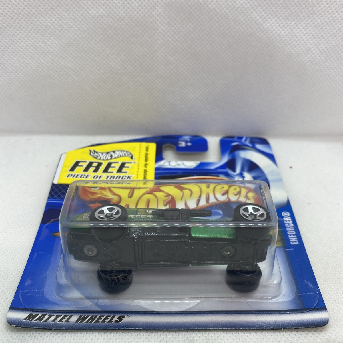 Hot Wheels Enforcer short card blister with black toy car, side view, sealed