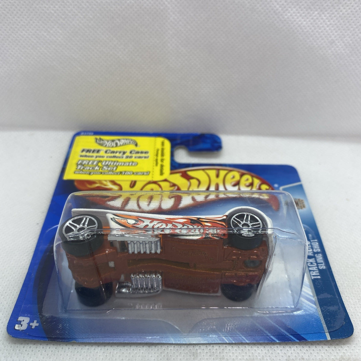 Toy car in clear blister on blue card, white body with orange graphic detailing