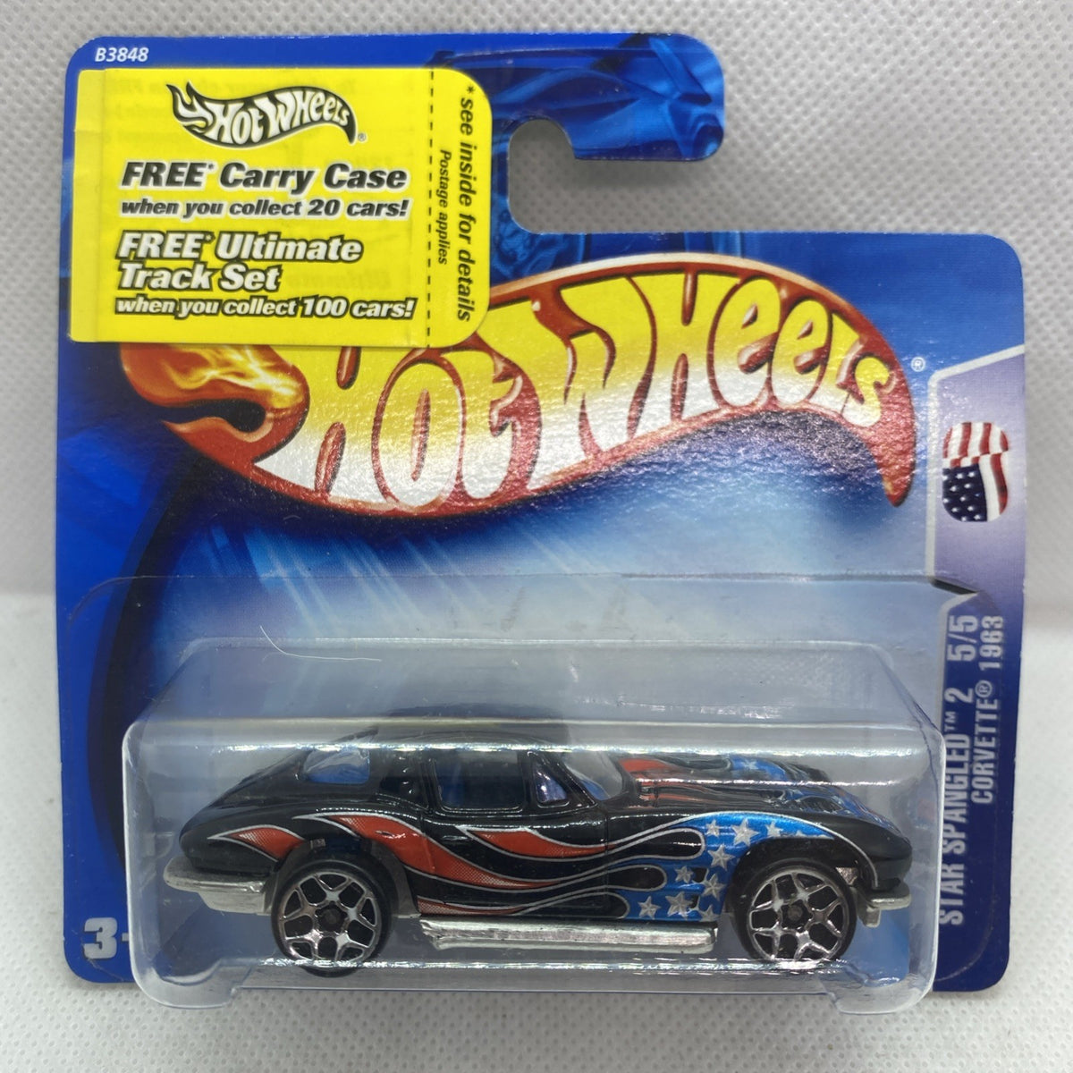 Hot Wheels Corvette die-cast on blue card, black base with blue stars and orange flame decals