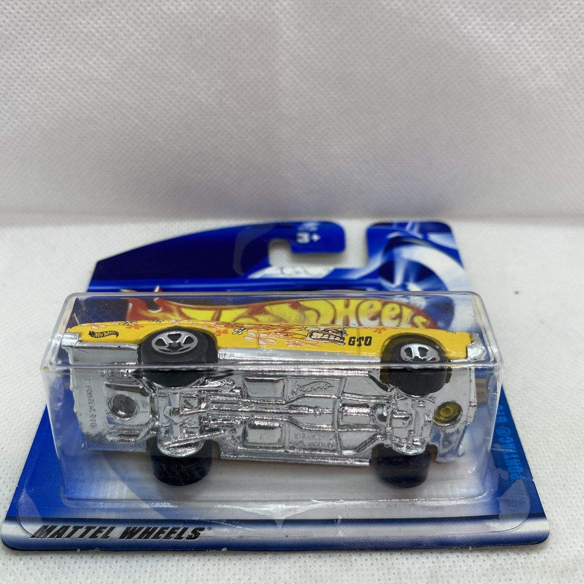 Die-cast car underside with chrome parts in clear blister on Hot Wheels card