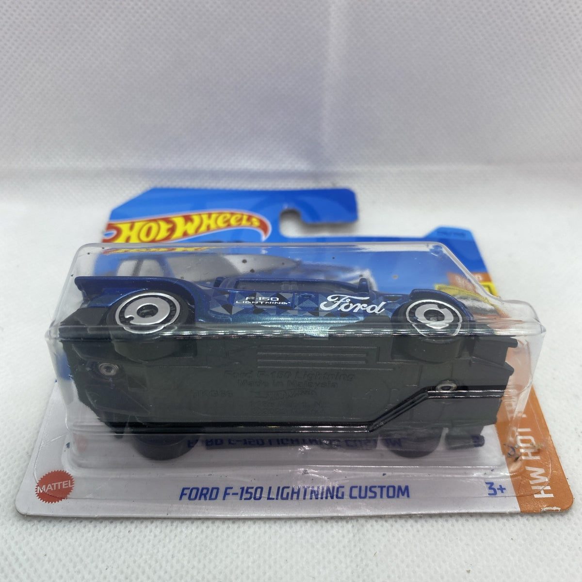 Hot Wheels Ford F-150 Lightning Custom die-cast truck in blue blister, front view