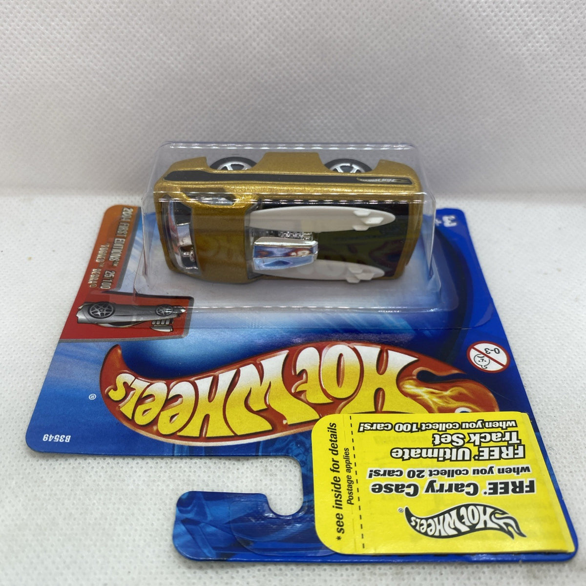 Hot Wheels gold and black car in blue blister pack, sealed