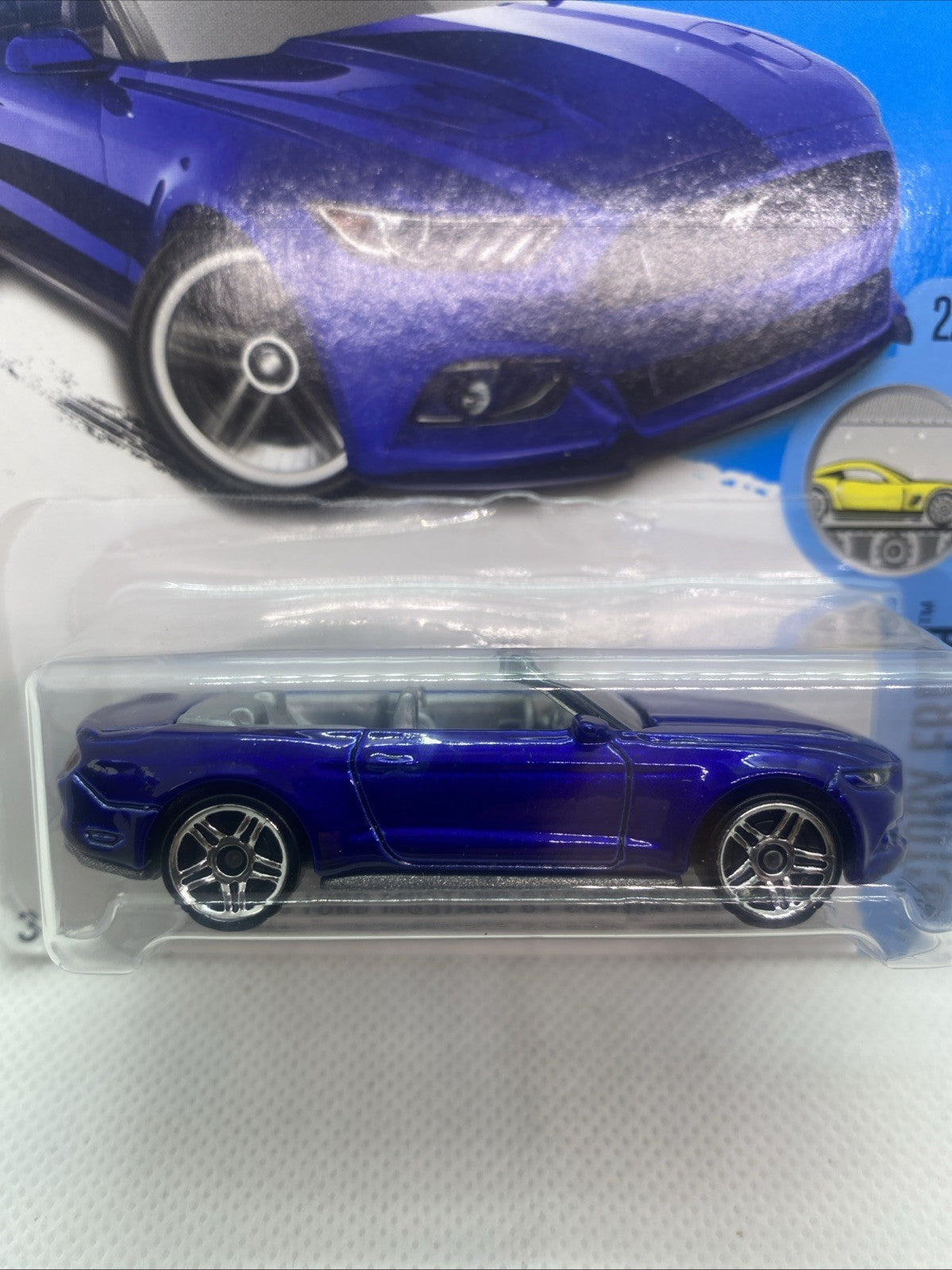 Hot Wheels blue die-cast convertible toy car in clear blister, side profile