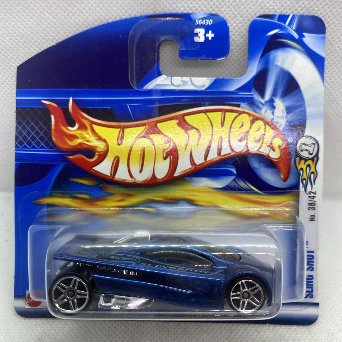 Hot Wheels die-cast car on blue blister card with flame graphics and blue car