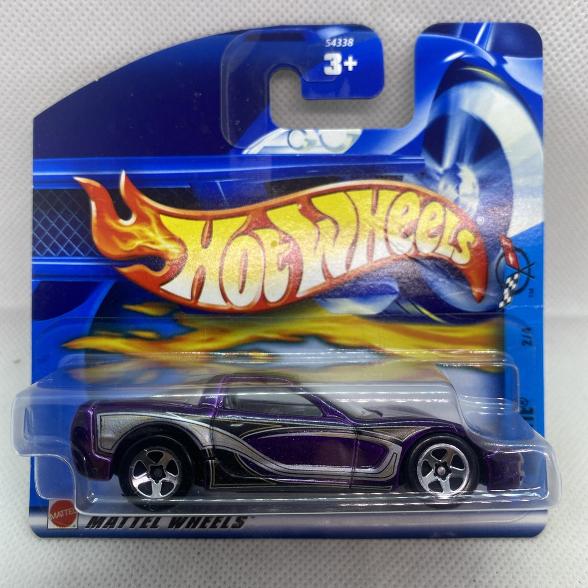 Purple/black Corvette die-cast in blue Hot Wheels blister, front view