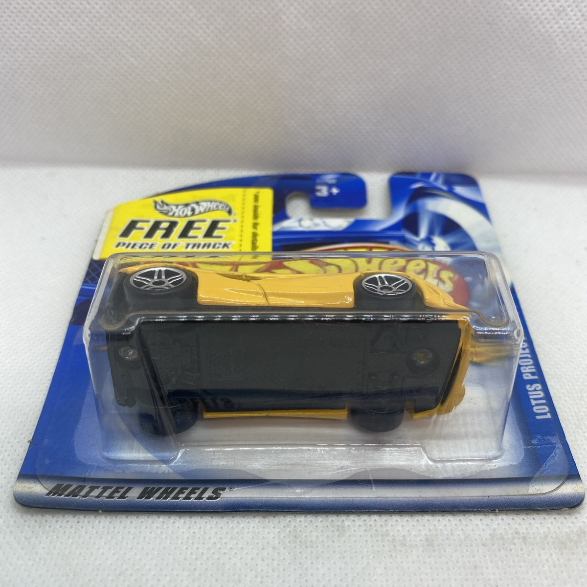 Yellow die-cast sports car in clear blister pack with rear view